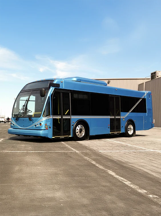 Blue heavy duty transit bus in a parking lot during the daytime