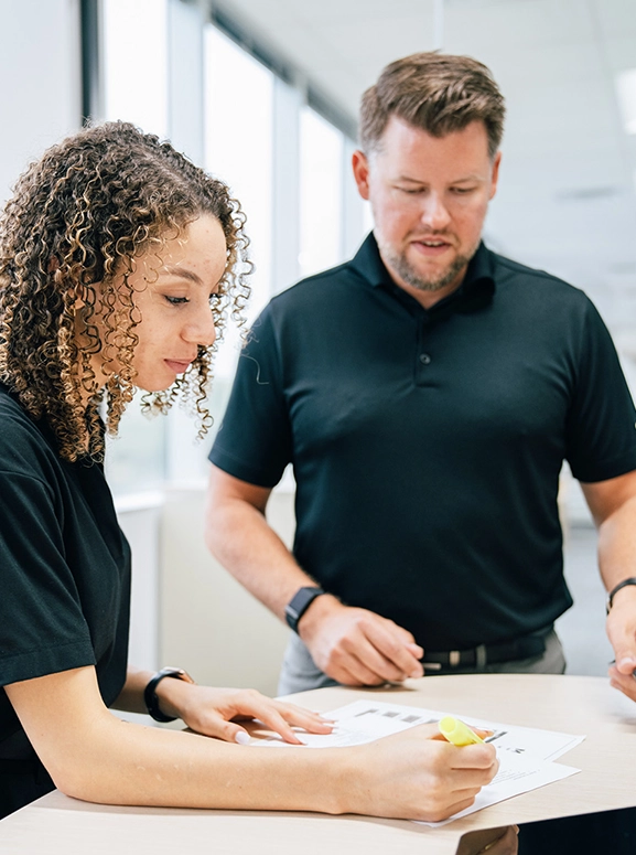 woman and man looking at forms for renting a vehicle in Portland
